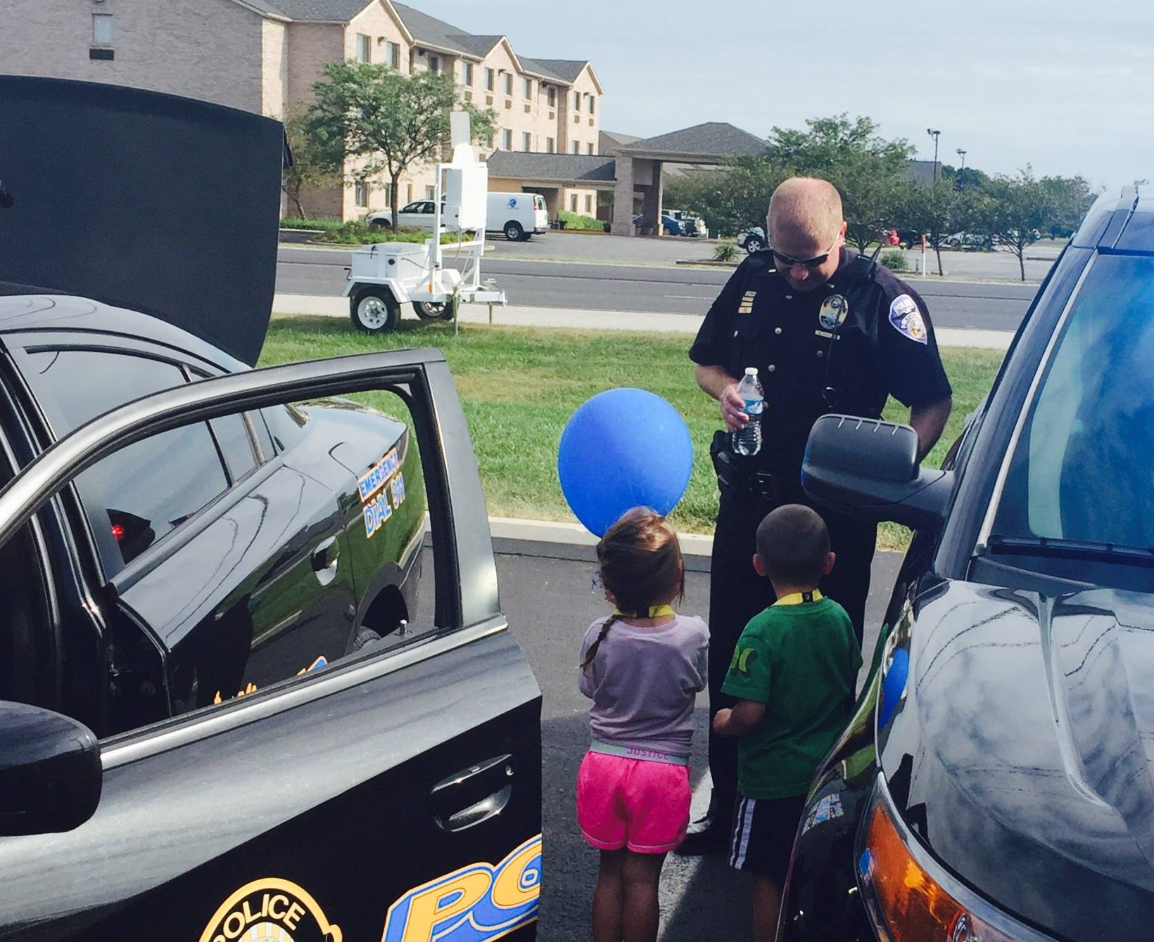 Police Office Speaking to Two Small Children