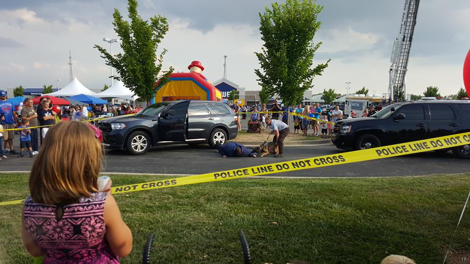 Police Perform K-9 Unit Exercise for Crowd Behind Caution Tape