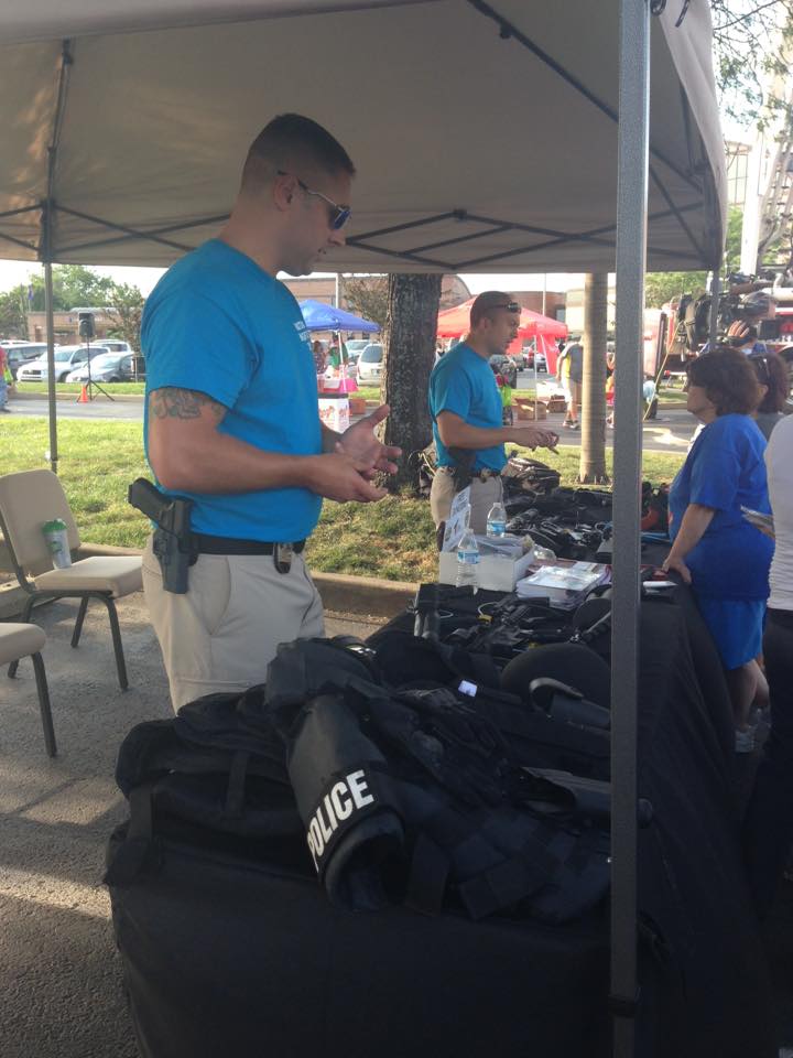 Police Volunteers at Booth Showing People Police Gear