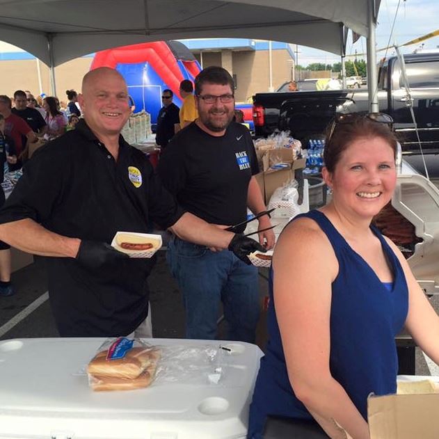 Volunteers Serving Food and Smiling for Picture